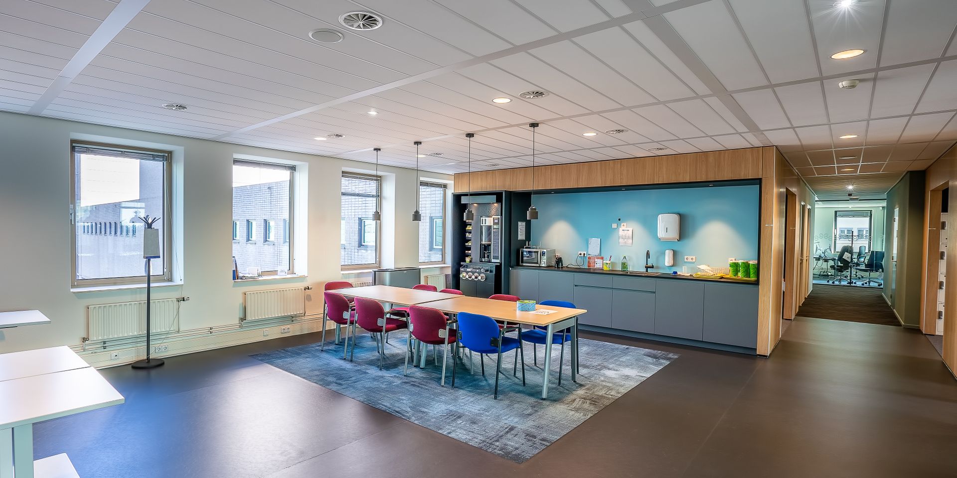 Bright modern office break room where vending machines are placed