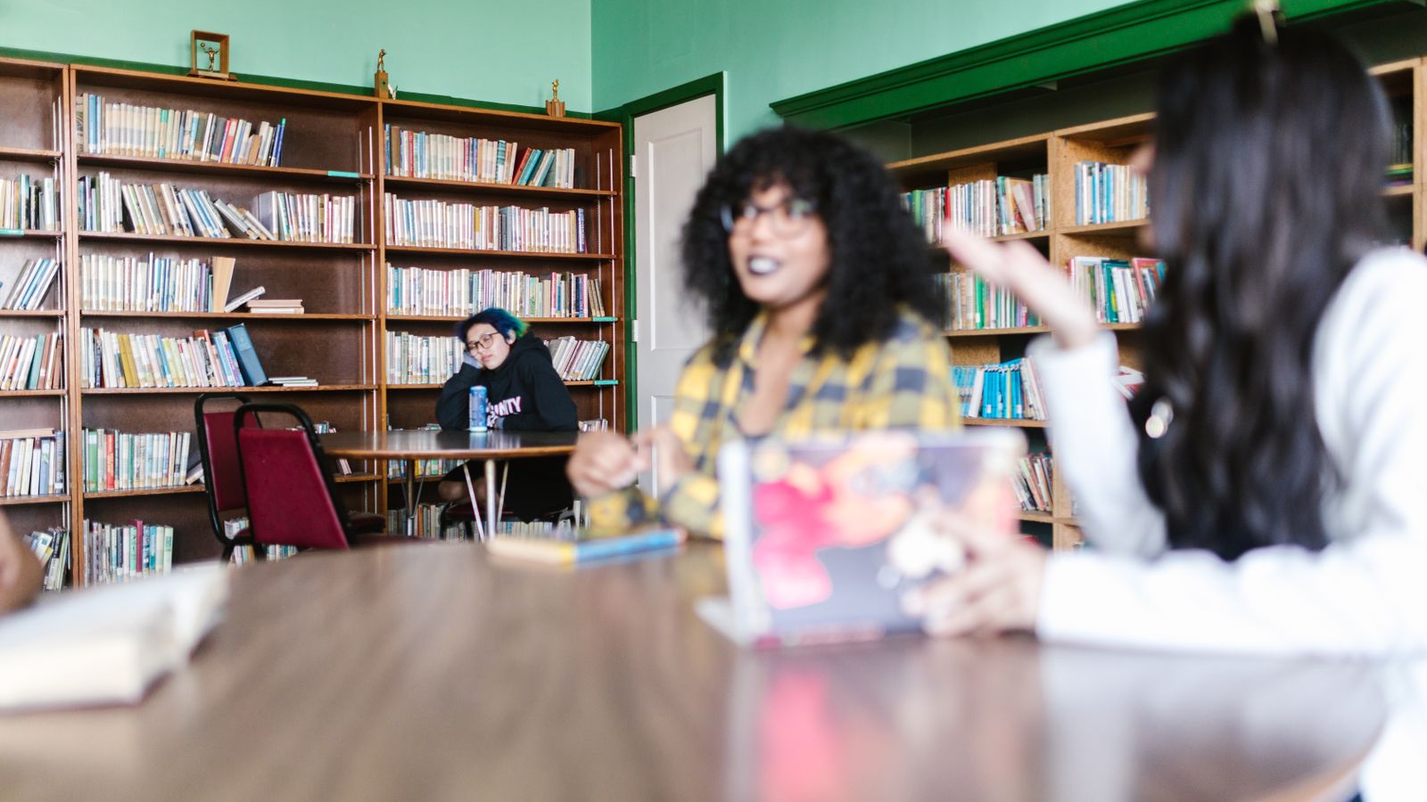 Students studying together at a table in a campus library
